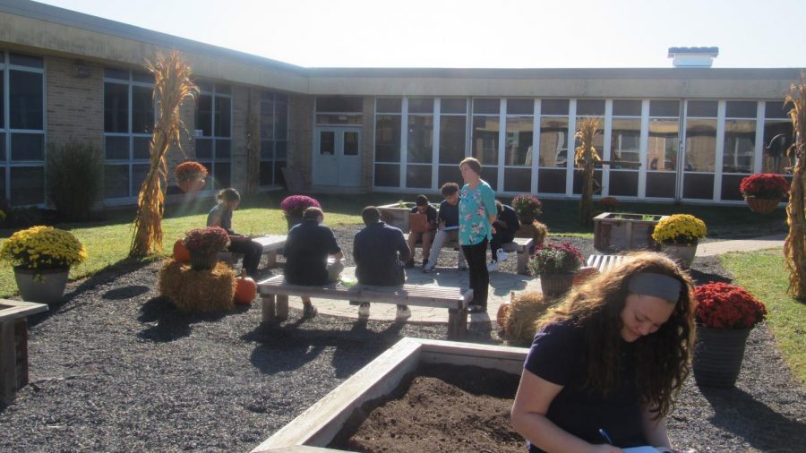 Ms. Deal and her Art 2 students in the Bernzomatic Garden for still-life practice.