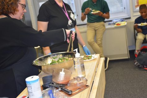 Chef continues preparing the salad while participating students dig in. Students reported enjoying the rainbow bowl.