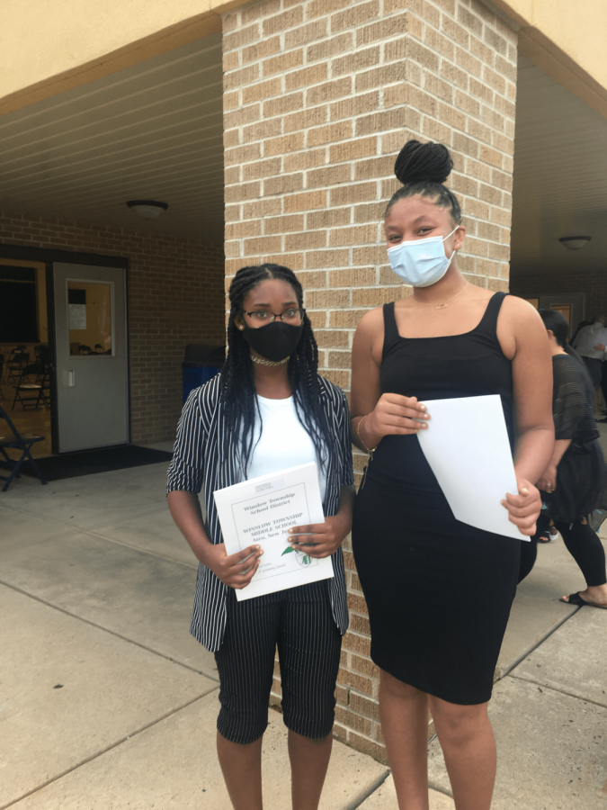 Editors Miah-Reese Govan and Talia Shumate pose together outside the cafeteria, celebrating their induction to NJHS.